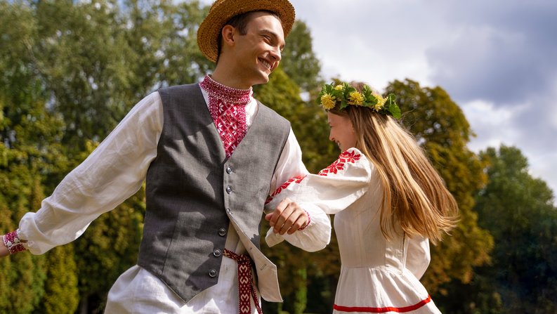 Auf dem Bild sind zwei Menschen beim Folktanz zu sehen. 